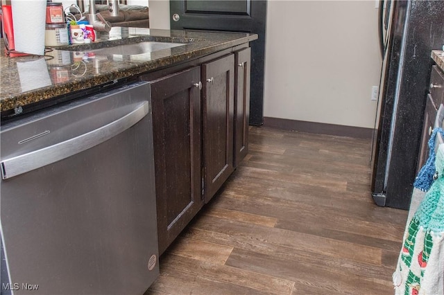 4691 Scenic Dr, Ravenna, OH 44266 - kitchen with stainless steel dishwasher, dark wood-style floors, dark brown cabinetry, and dark stone countertops