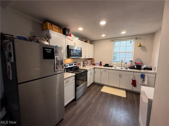 845 S Liberty Ave, Alliance, OH 44601 - kitchen featuring stainless steel appliances, a sink, light countertops, dark wood-style flooring, and white cabinets