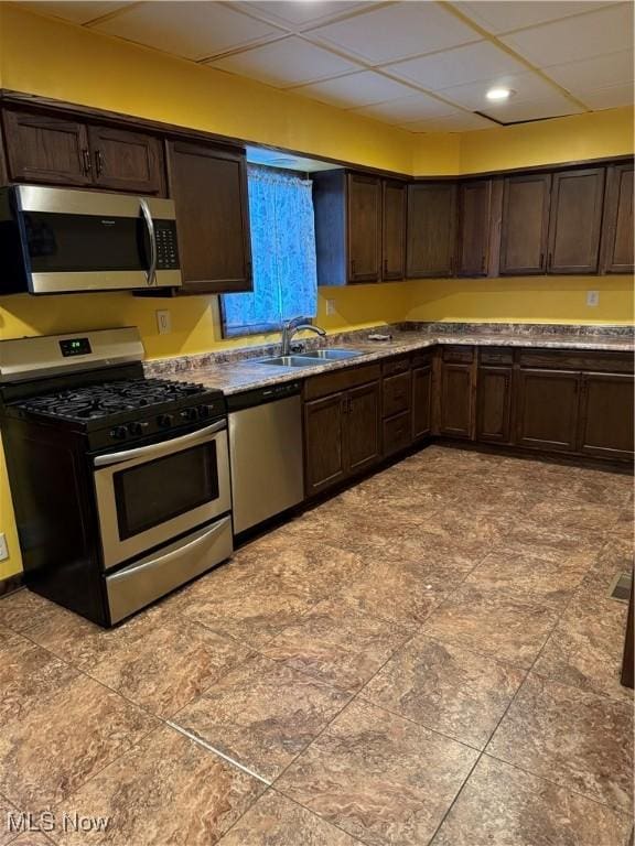 55960 National Rd, Bridgeport, OH 43912 - kitchen with appliances with stainless steel finishes, a sink, dark brown cabinetry, and recessed lighting