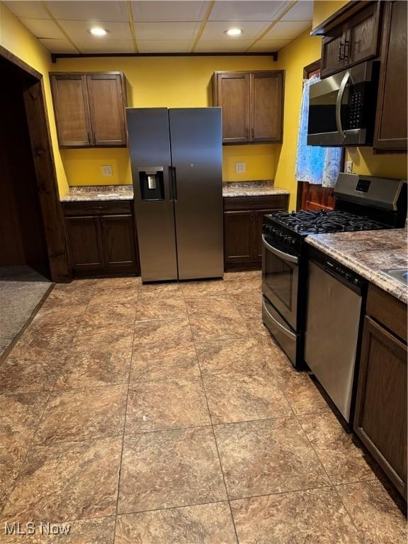 55960 National Rd, Bridgeport, OH 43912 - kitchen featuring stainless steel appliances, a drop ceiling, dark brown cabinets, and recessed lighting