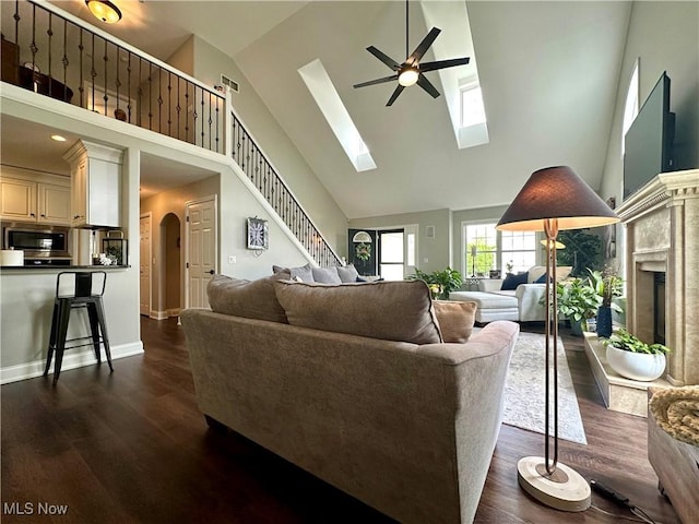 6836 Twin Oaks Ct, Canfield, OH 44406 - living room featuring high vaulted ceiling, ceiling fan, dark wood finished floors, arched walkways, and stairway