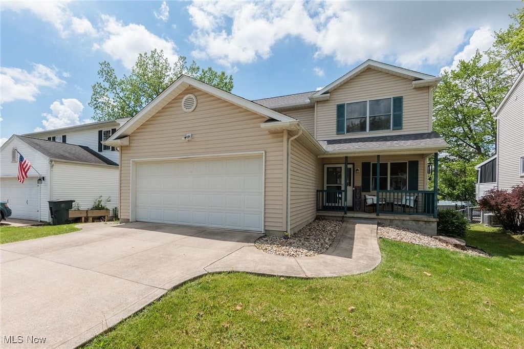 354 Ivanhoe Ave, Wadsworth, OH 44281 - traditional-style house featuring a porch, an attached garage, a front lawn, and driveway
