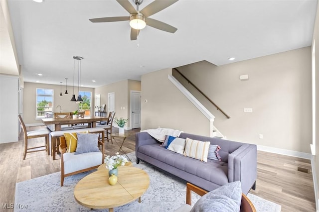 2087 Wynn Rd, Cleveland, OH 44118 - living room featuring light wood-type flooring, recessed lighting, stairs, a ceiling fan, and baseboards