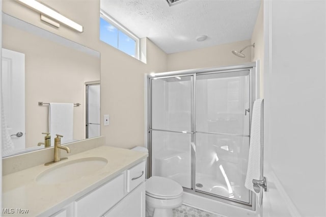 2087 Wynn Rd, Cleveland, OH 44118 - full bathroom featuring a shower stall, toilet, vanity, and a textured ceiling