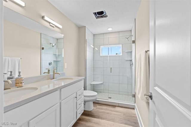 2087 Wynn Rd, Cleveland, OH 44118 - full bath featuring a shower stall, toilet, wood finished floors, and double vanity