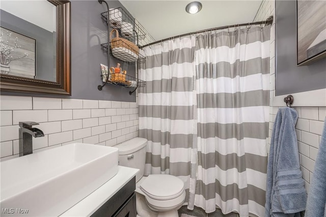 272 Cheyenne Trl, Malvern, OH 44644 - bathroom with tile walls, toilet, a shower with shower curtain, and vanity
