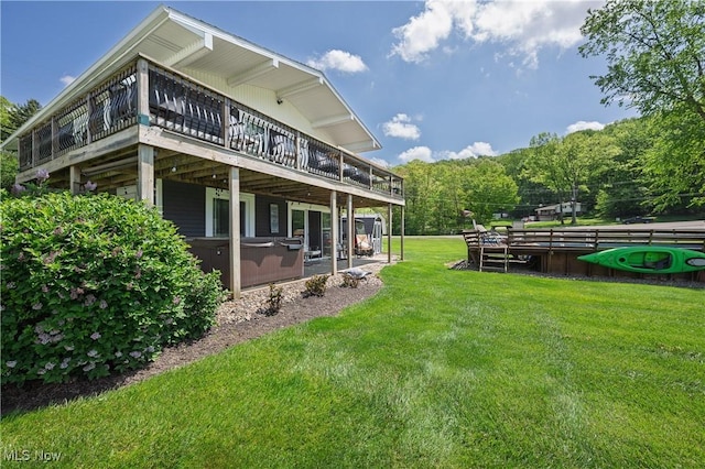 272 Cheyenne Trl, Malvern, OH 44644 - back of house with a wooden deck, a yard, and a hot tub