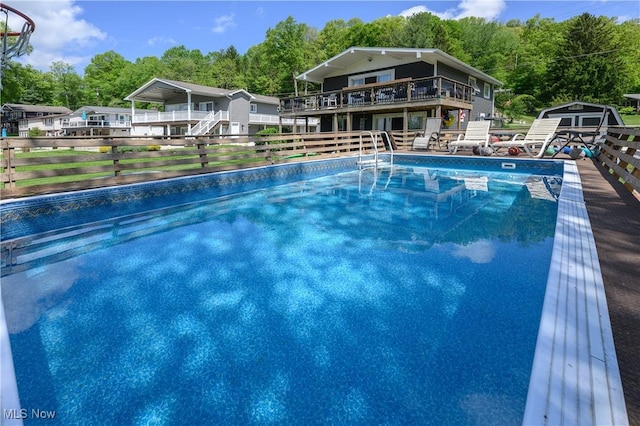 272 Cheyenne Trl, Malvern, OH 44644 - outdoor pool featuring a storage shed, an outbuilding, a fenced backyard, a wooden deck, and stairway