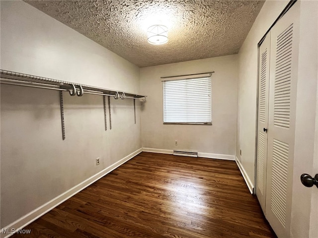 1585 Hilda St, Lakemore, OH 44250 - unfurnished bedroom featuring a textured ceiling, wood finished floors, a closet, and baseboards