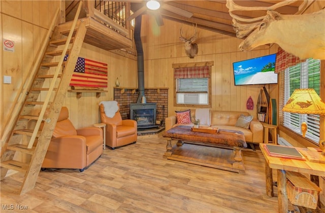 7324 Ferngreen Rd, Carrollton, OH 44615 - living area with wood walls, lofted ceiling, wood finished floors, a wood stove, and a ceiling fan