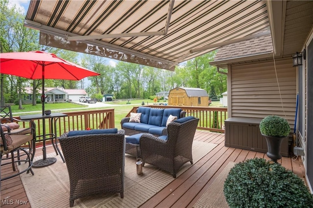 114 W Cherokee Trl, Bayview, OH 44870 - deck featuring a storage unit, an outbuilding, a lawn, and outdoor lounge area