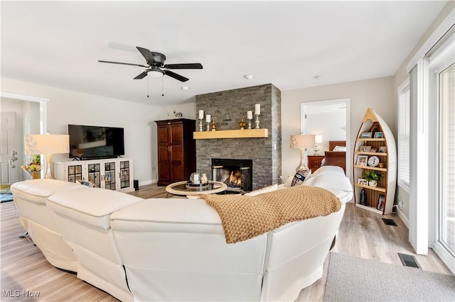 114 W Cherokee Trl, Bayview, OH 44870 - living room featuring light wood-style floors, a fireplace, a ceiling fan, and baseboards