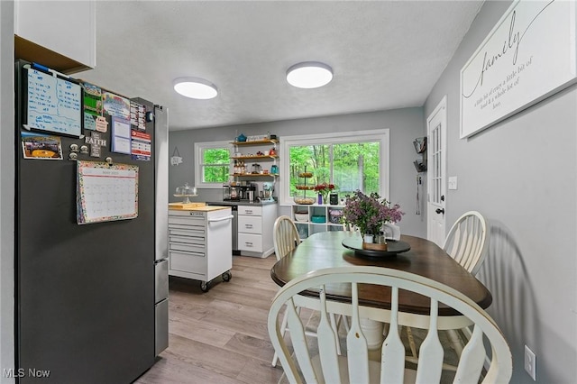 dining room with plenty of natural light and light wood finished floors