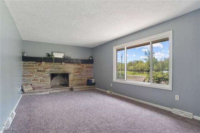 10699 Whippoorwill Rd, Newton Falls, OH 44412 - unfurnished living room featuring carpet, a stone fireplace, a textured ceiling, and baseboards