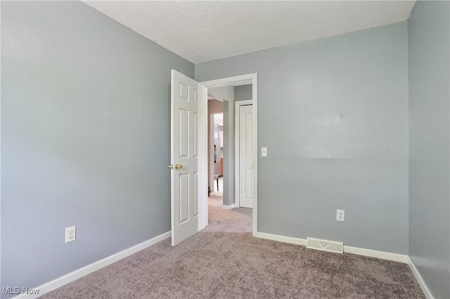 10699 Whippoorwill Rd, Newton Falls, OH 44412 - unfurnished room with carpet floors, baseboards, and a textured ceiling