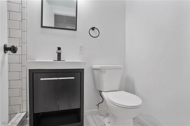 bathroom with marble look tiles, baseboards, toilet, and vanity