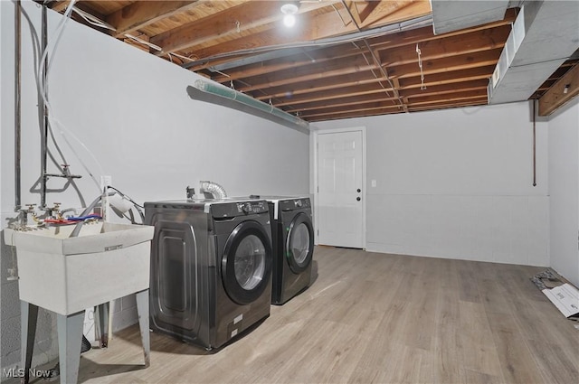 laundry area featuring washing machine and clothes dryer and wood finished floors