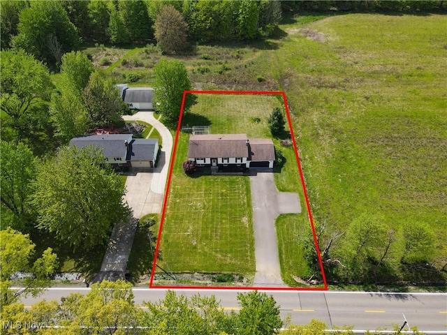 aerial view of property and surrounding area with property parcel outlined