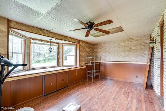7026 S Boyden, Northfield, OH 44067 - spare room with plenty of natural light, a wainscoted wall, light wood-type flooring, a ceiling fan, and a drop ceiling