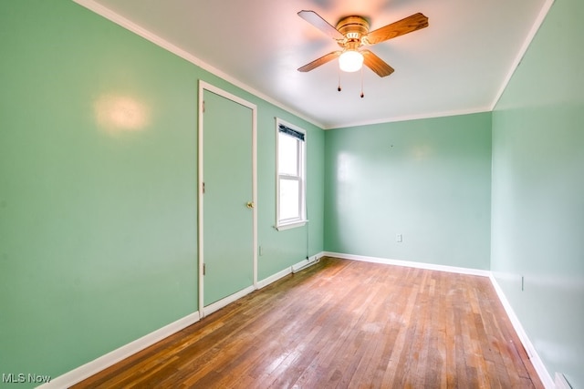 7026 S Boyden, Northfield, OH 44067 - spare room featuring ornamental molding, baseboards, hardwood / wood-style flooring, and a ceiling fan