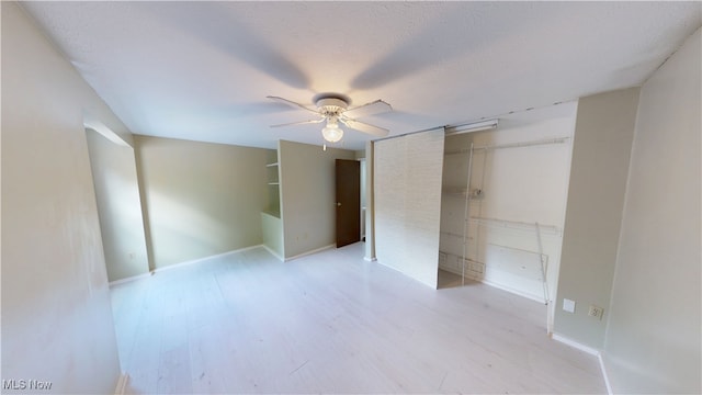 3853 Lake Run Blvd, Stow, OH 44224 - unfurnished bedroom featuring wood finished floors, a ceiling fan, baseboards, and a closet