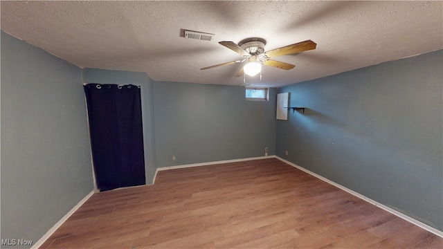 3853 Lake Run Blvd, Stow, OH 44224 - spare room featuring wood finished floors, a ceiling fan, a textured ceiling, and baseboards