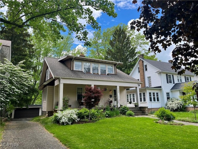 2508 Queenston Rd, Cleveland Heights, OH 44118 - view of front facade featuring a front yard, a garage, covered porch, a chimney, and an outdoor structure
