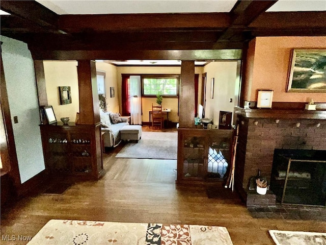 2508 Queenston Rd, Cleveland Heights, OH 44118 - living area with wood finished floors, beam ceiling, and a brick fireplace