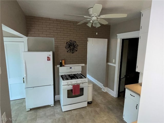 2508 Queenston Rd, Cleveland Heights, OH 44118 - kitchen featuring white appliances, ceiling fan, brick wall, white cabinetry, and light countertops