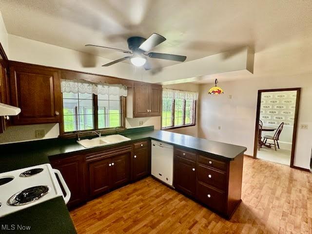 13053 Sarbaugh St SW, Navarre, OH 44662 - kitchen featuring white dishwasher, a sink, a ceiling fan, a peninsula, and dark countertops
