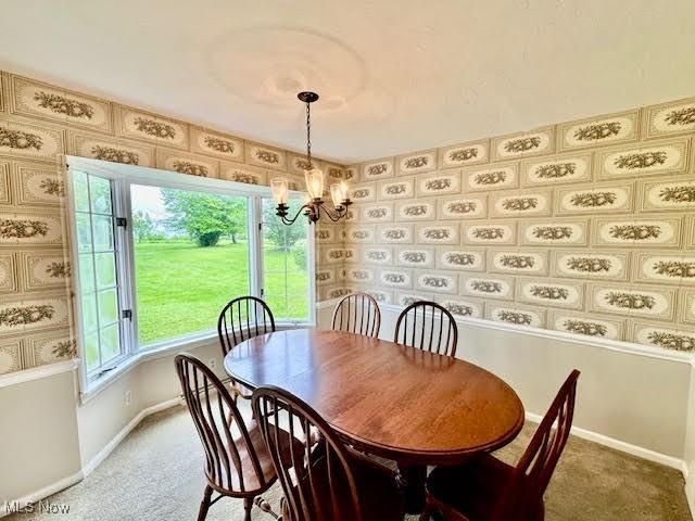 13053 Sarbaugh St SW, Navarre, OH 44662 - dining room with a chandelier, carpet, and baseboards