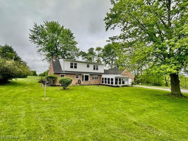 13053 Sarbaugh St SW, Navarre, OH 44662 - rear view of house featuring a chimney and a yard