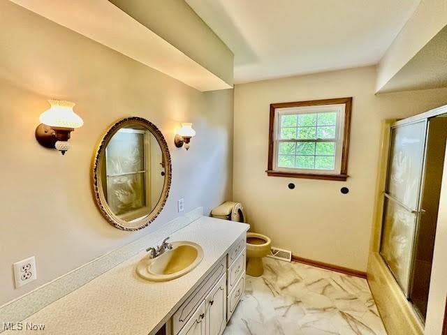 13053 Sarbaugh St SW, Navarre, OH 44662 - full bathroom with an enclosed shower, vanity, marble finish floors, toilet, and baseboards