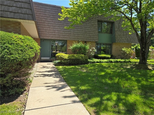 459 W Streetsboro St Unit F, Hudson, OH 44236 - view of front of house featuring mansard roof, brick siding, and a front lawn