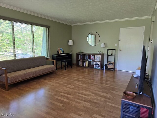 459 W Streetsboro St Unit F, Hudson, OH 44236 - living room with wood finished floors, a textured ceiling, crown molding, and baseboards