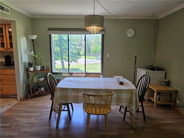 459 W Streetsboro St Unit F, Hudson, OH 44236 - dining room with wood finished floors, a chandelier, crown molding, and a textured ceiling