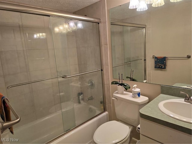459 W Streetsboro St Unit F, Hudson, OH 44236 - bathroom featuring a chandelier, a textured ceiling, bath / shower combo with glass door, vanity, and toilet