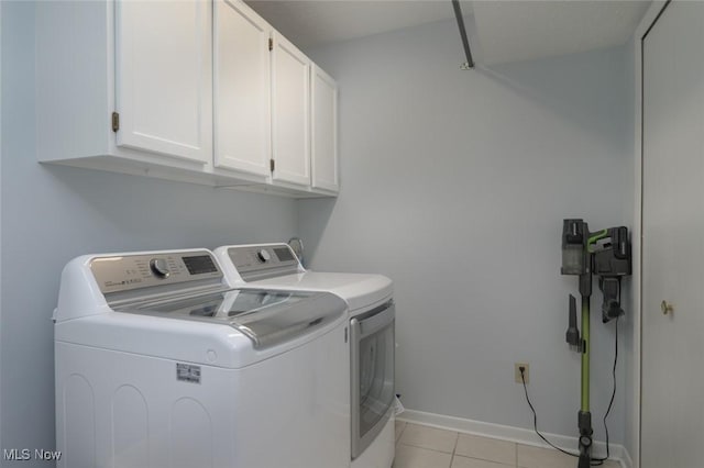 laundry room with cabinet space, independent washer and dryer, light tile patterned flooring, and baseboards