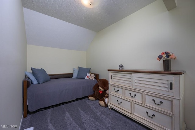 bedroom featuring lofted ceiling, carpet, and a textured ceiling
