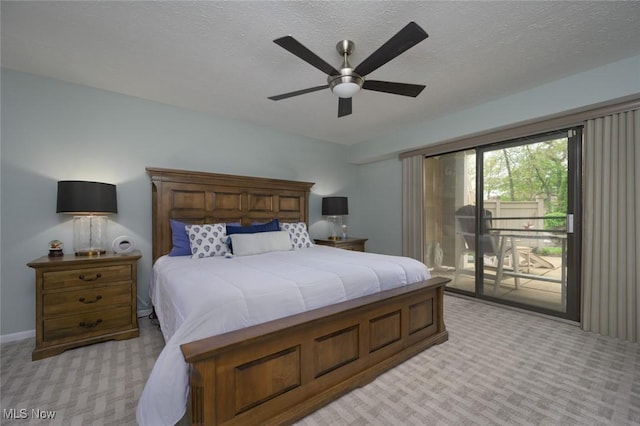 bedroom with light colored carpet, access to exterior, a ceiling fan, and a textured ceiling