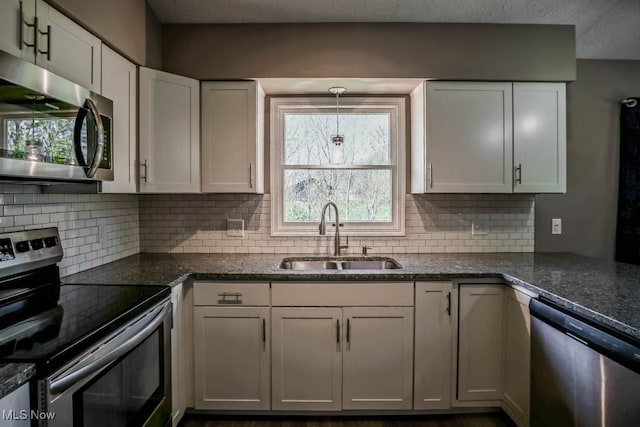 5291 Francesca St NE, Louisville, OH 44641 - kitchen with stainless steel appliances, a sink, backsplash, and white cabinets
