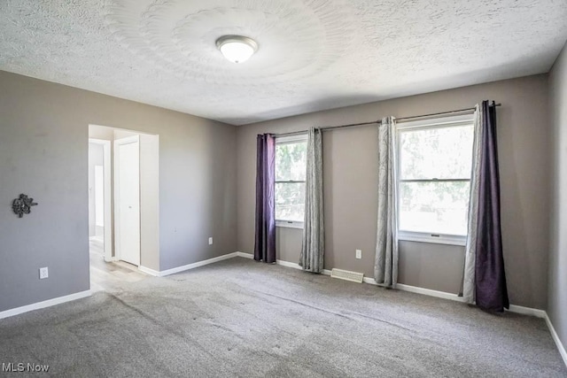 5291 Francesca St NE, Louisville, OH 44641 - carpeted spare room featuring a textured ceiling and baseboards