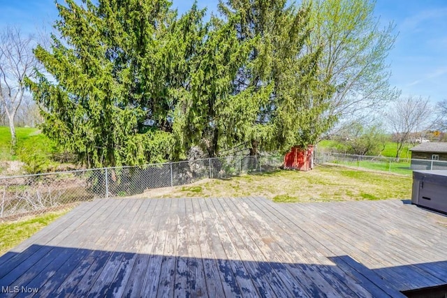 5291 Francesca St NE, Louisville, OH 44641 - wooden deck featuring a storage shed and an outbuilding