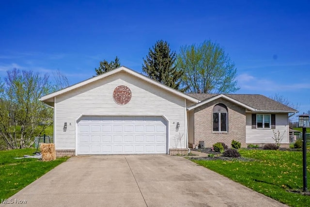 5291 Francesca St NE, Louisville, OH 44641 - ranch-style home featuring a front yard, concrete driveway, brick siding, and a garage