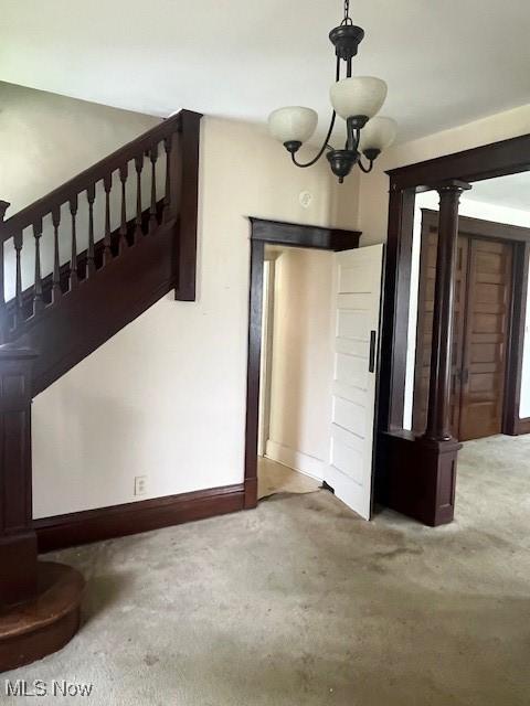 139 Chapman St, Zanesville, OH 43701 - unfurnished dining area featuring carpet, stairs, and baseboards