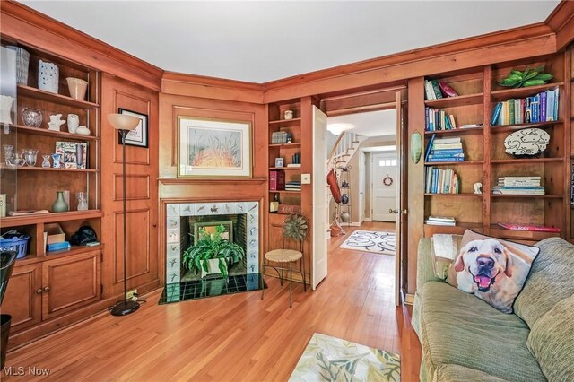 3711 Sampson Rd, Youngstown, OH 44505 - living room with stairway, light wood-style flooring, ornamental molding, and built in shelves