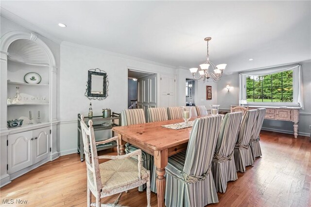 3711 Sampson Rd, Youngstown, OH 44505 - dining area featuring a chandelier, light wood finished floors, and crown molding