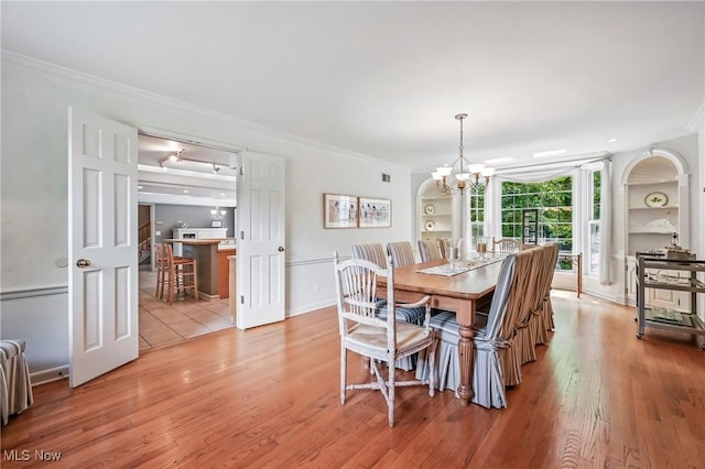 3711 Sampson Rd, Youngstown, OH 44505 - dining room with ornamental molding, a chandelier, wood finished floors, and built in shelves