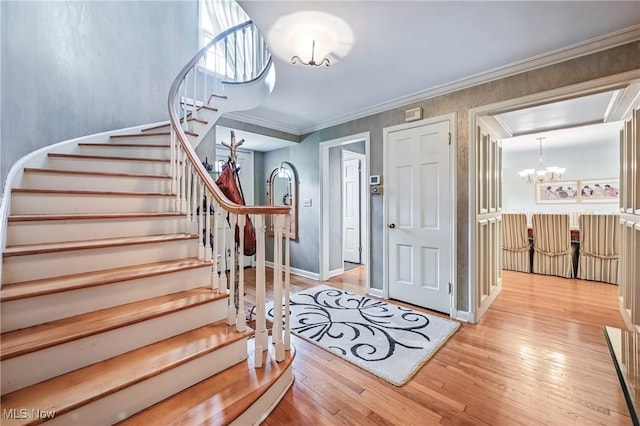 3711 Sampson Rd, Youngstown, OH 44505 - entryway featuring a chandelier, stairway, hardwood / wood-style floors, ornamental molding, and baseboards