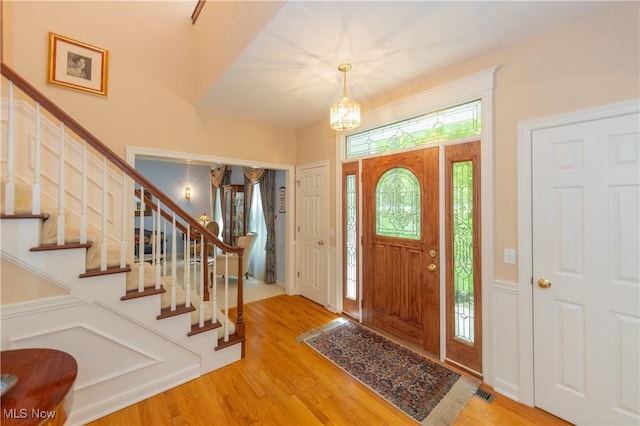 1030 Whisperwood Ln, Aurora, OH 44202 - entryway with wood finished floors, stairs, and a chandelier